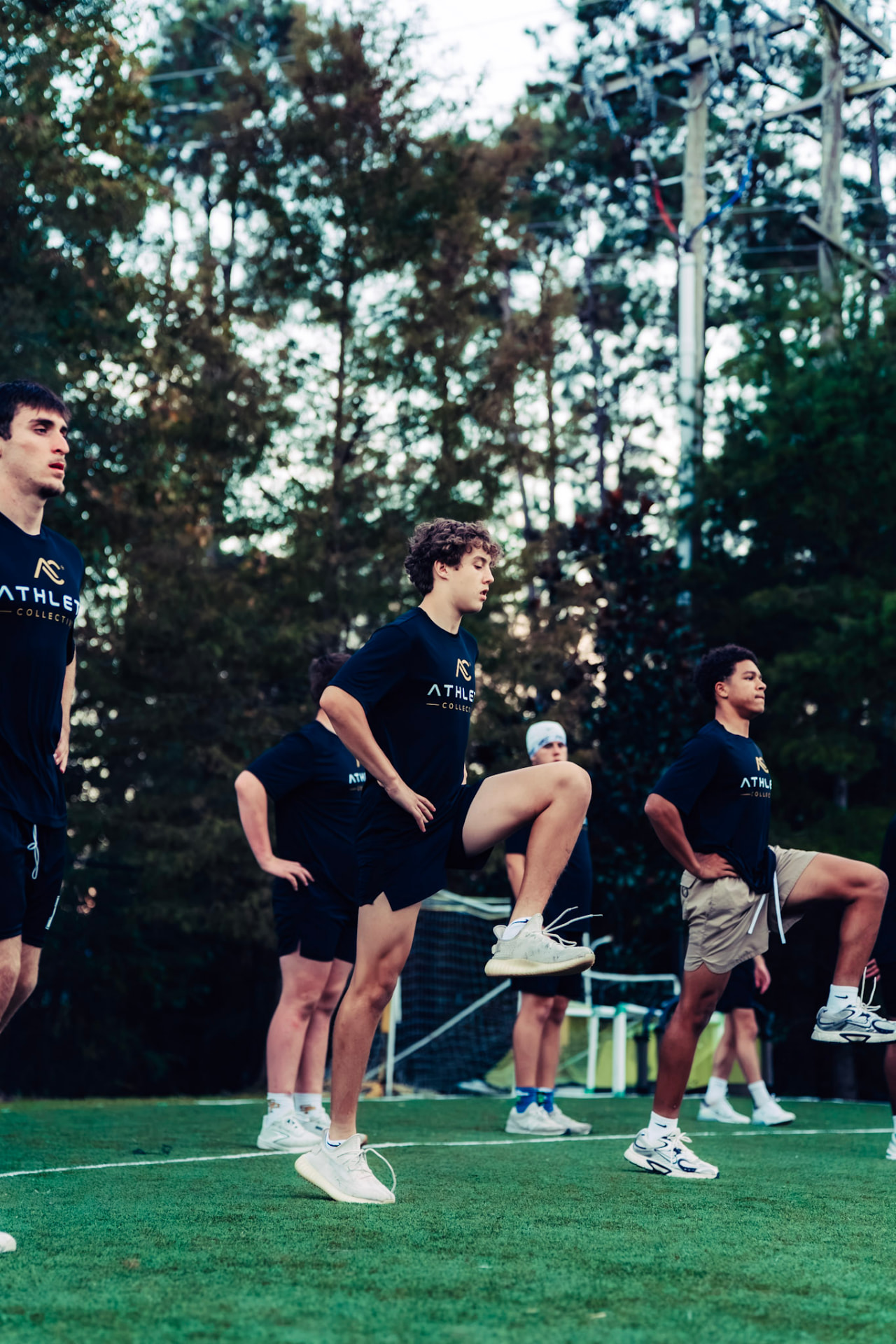 Athlete Collective athletes practicing high-knee movement drills together