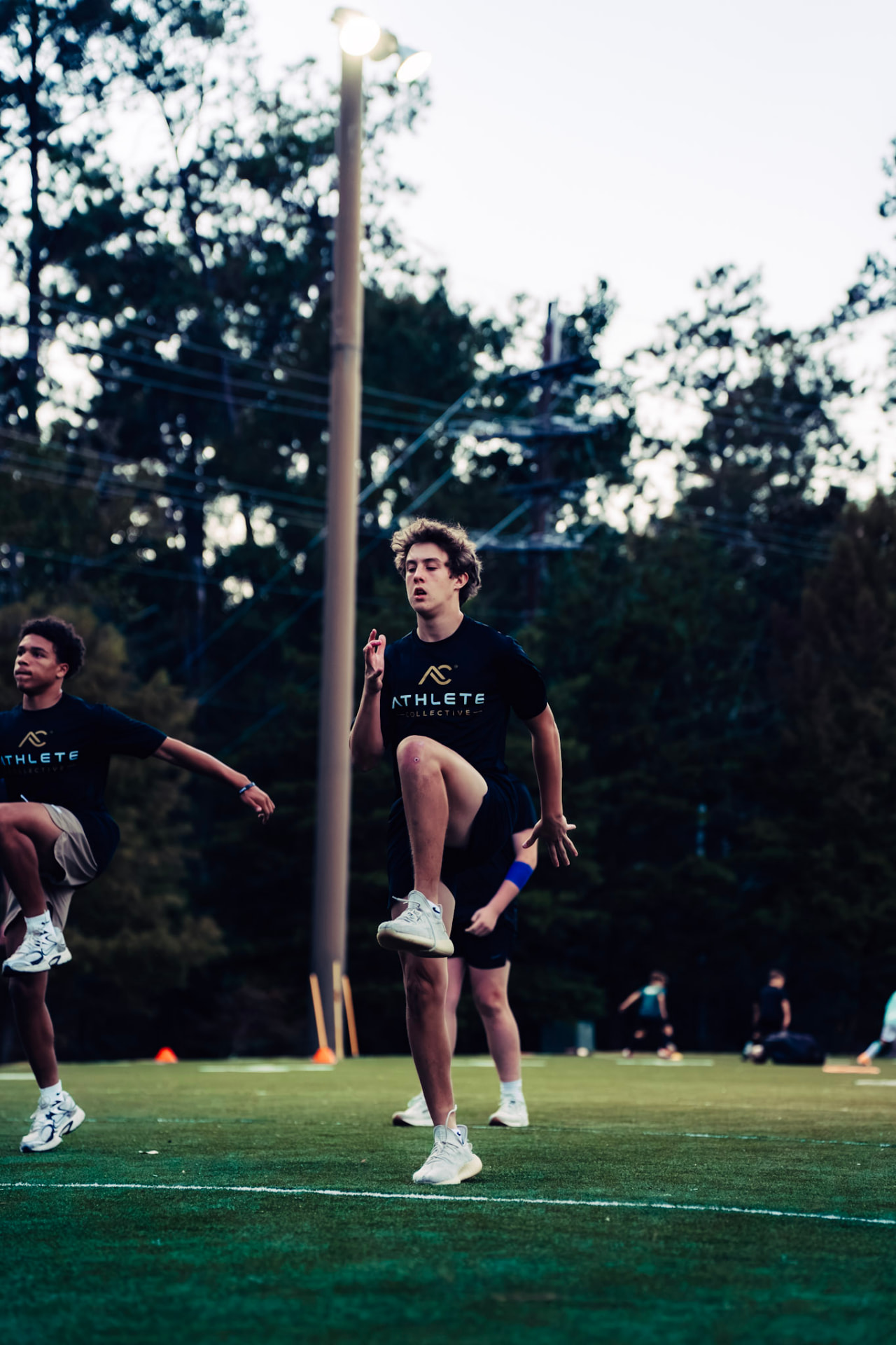 Athlete practicing sprint mechanics during a turf training session