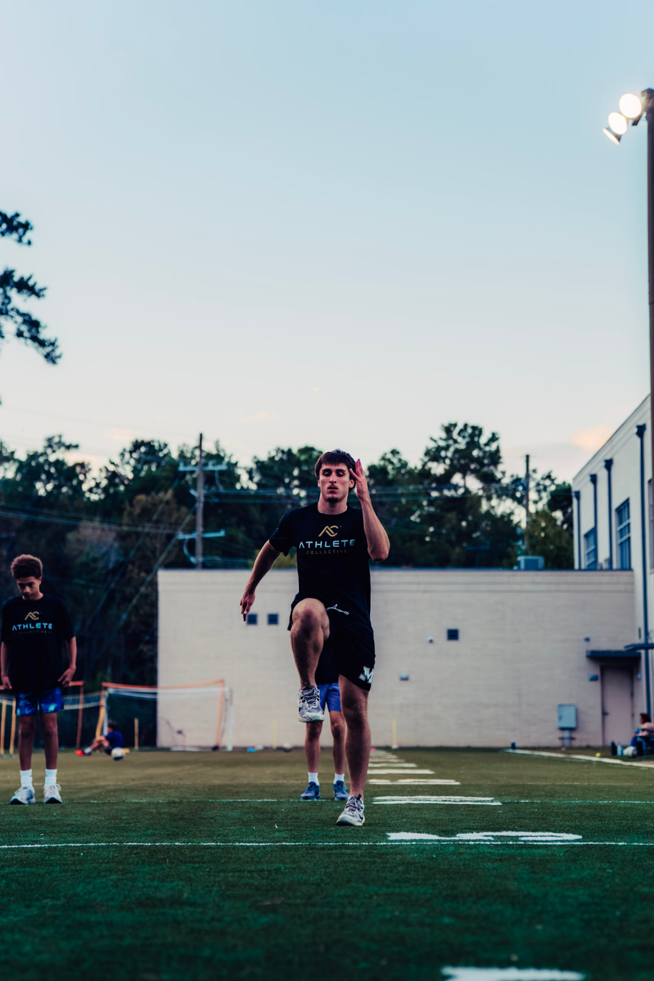 Athlete working through a running drill on the Athlete Collective turf